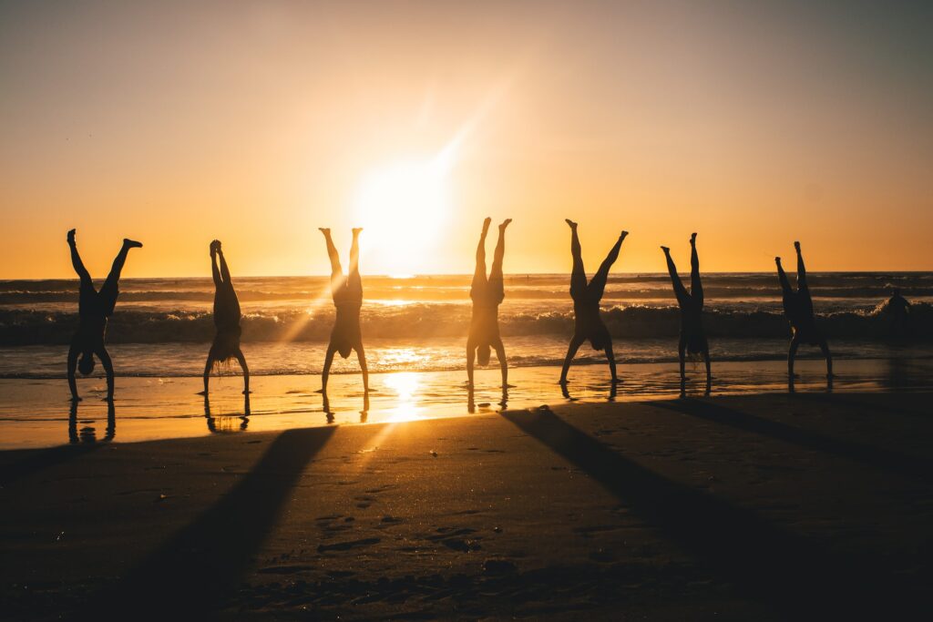 A group of people performing Handstands. A popular calisthenics movement.